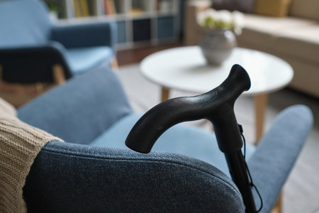 Close-up of crutch leaning on the sofa for senior person in the living roomの写真素材
