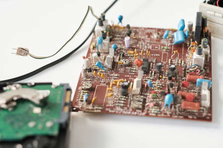 Part of circuit board with many tiny details, electronic schemes and cords on white backgroundの写真素材