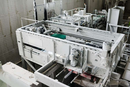 Part of spacious workshop or plant with huge machine or other technical equipment prepared for...