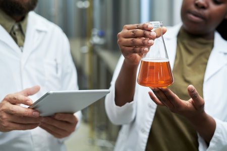 Laboratory workers checking quality of beer produced at microbreweryの写真素材