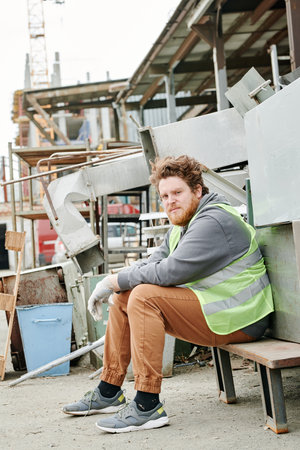 Volunteer resting outside after work at working at materials recovery facilityの写真素材