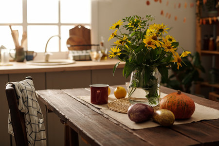 Composition of fresh wildflowers in vase or jar standing on wooden table with metallic mug, fresh...