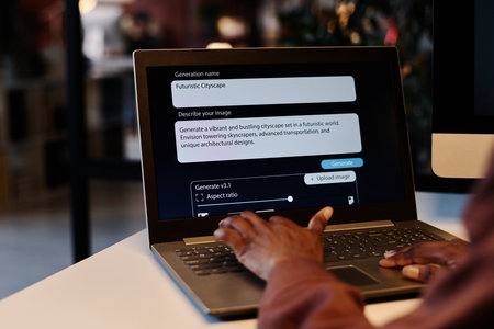 Hand of young unrecognizable African American woman typing on keyboard of laptop with assignment text on screenの写真素材