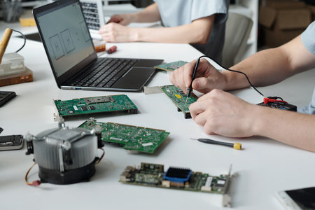Hands of young unrecognizable engineer or repairman of troubleshooting service center repairing or...