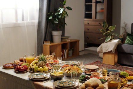 No people shot of living room interior with abundance of delicious dishes on festive table for Islamic holiday celebration, copy spaceの写真素材