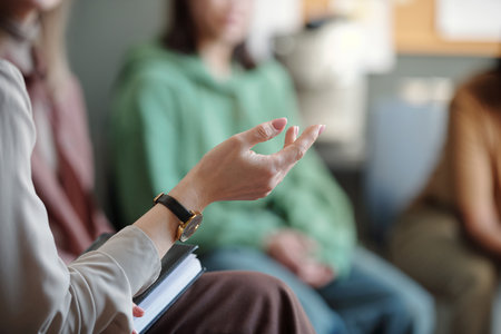 Hand of unrecognizable female counselor consulting patient at session or explaining main factors...