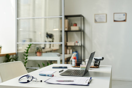 Laptop surrounded by medical supplies standing on workplace of modern teledoc or general practitioner in the center of spacious officeの写真素材