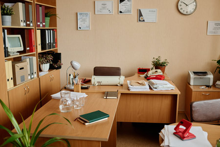 Office setup showcasing modern and classic items including shelves filled with files and books, a...