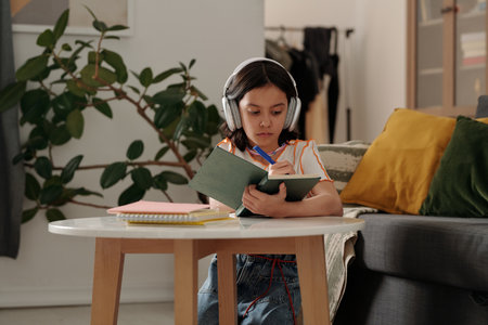 Young girl wearing headphones studying in cozy room with plants and books surrounding her, focused...