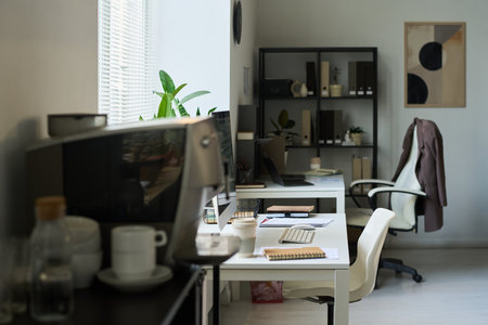Workplaces of modern economists or managers with desktop computers, notepads and other office supplies on desksの写真素材