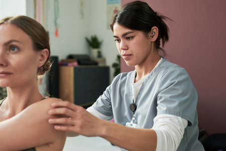 Medical professional wearing scrubs attentively administering injection to patient in clinical...