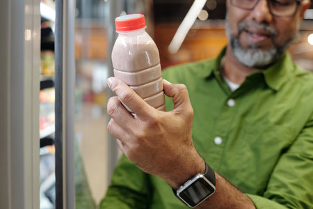 Indian Man Choosing Dairy Productsの写真素材