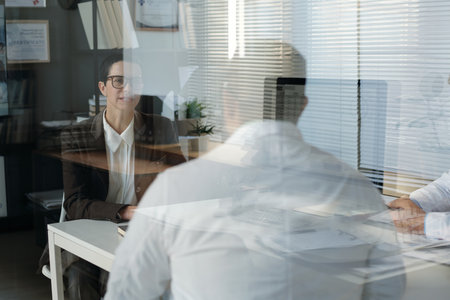 Female Medical Expert at Desk at Meeting with Doctorの写真素材