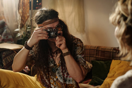 Capturing Moments with Vintage Camera in Cozy Roomの写真素材