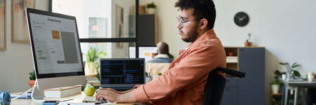 Header of young multiethnic man with disability sitting in wheelchair and typing on keyboard while...