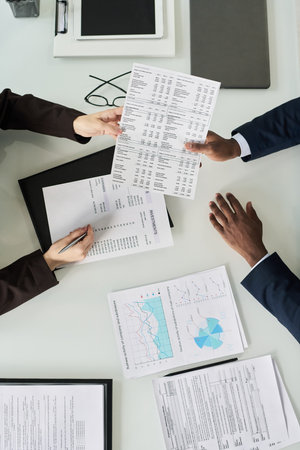 Business Colleagues Examining Financial Documents At Meetingの写真素材