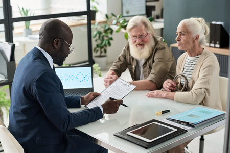 Financial Manager Examining Application Of Senior Coupleの写真素材