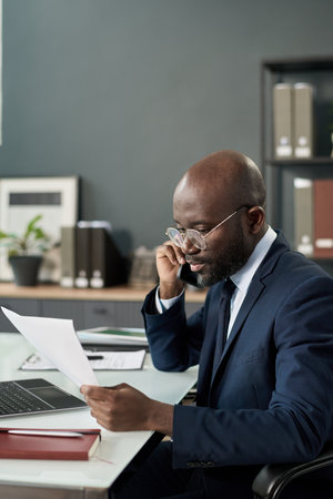Businessman Talking On The Phone In Officeの写真素材