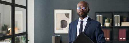 Businessman With Folder In Office