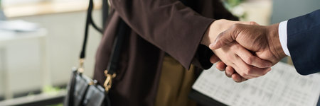 Business Colleagues Shaking Hands In Officeの写真素材