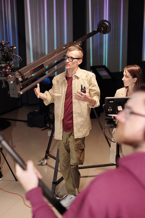 Cameraman and his assistant shooting program in studio