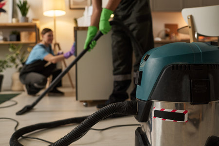 Worker Using Vacuum Cleaner During Houseworkの写真素材
