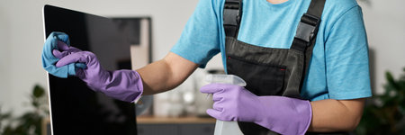 Woman Wiping Screen Of Computerの写真素材