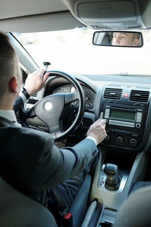 Disabled businessman in formalwear driving car while coming back home after work