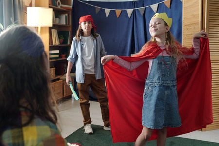 Group of children enjoying a playful moment dressed in colorful costumes. Room is decorated with...