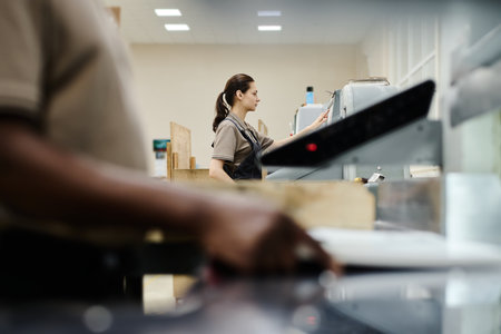Selective focus shot of unrecognizable black man and caucasian woman working in modern printing...