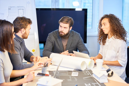 Team of designers discussing new project. Creative young people working on new apartment interior...