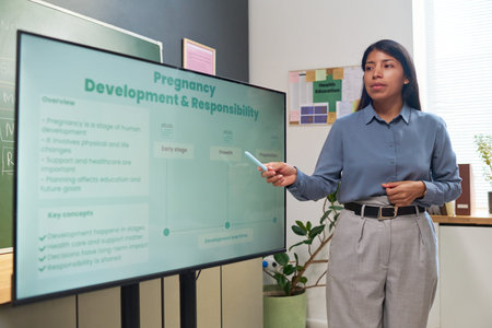 Young adult Hispanic woman presenting pregnancy development and responsibility information on...