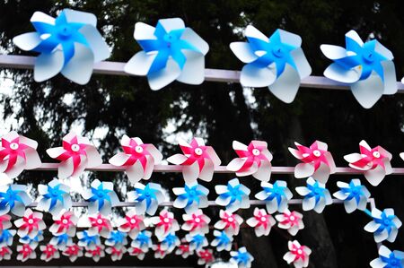 Red and blue wind spinnersの写真素材