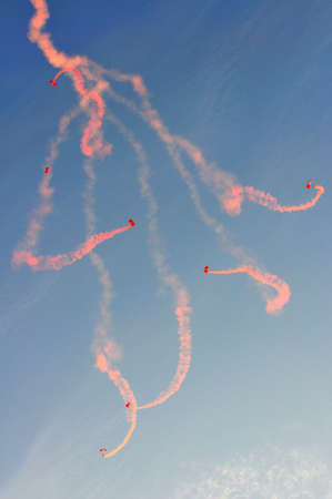 Red Lions free falling, creating rose petal pattern with orange smoke during National Day Parade Singapore 2011 Combined Rehearsal on June 25, 2011 in Singaporeのeditorial素材