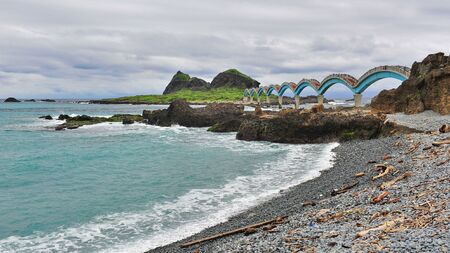 Eight arch bridge leading to scenic and volcanic San Xian Tai island in Taiwanの写真素材