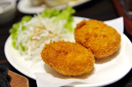 Japanese croquette fried to perfect golden brownの写真素材