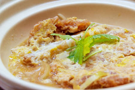 Japanese fried pork chop omelet and rice cooked in clay-potの写真素材