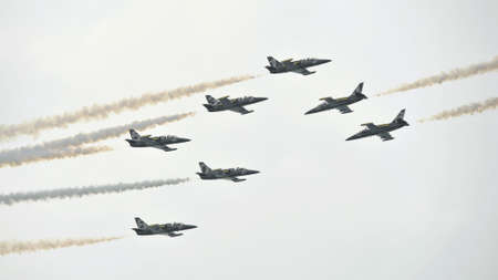 Planes crossing aerobatics display by Breitling Jet Team at Sentosa Siloso Beach March 9, 2013 in Singaporeのeditorial素材