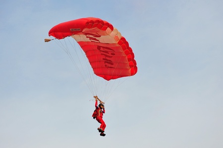 SINGAPORE - JULY 20: The Red Lions sky diving during National Day Parade (NDP) Rehearsal 2013 on...