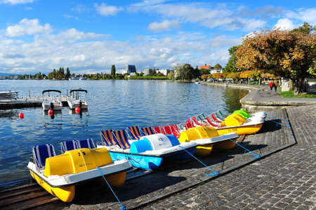 Row of colorful recreation boats beside Lake Zug in Switzerlandの写真素材