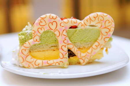 Green tea cake with heart shape sugar icingの写真素材