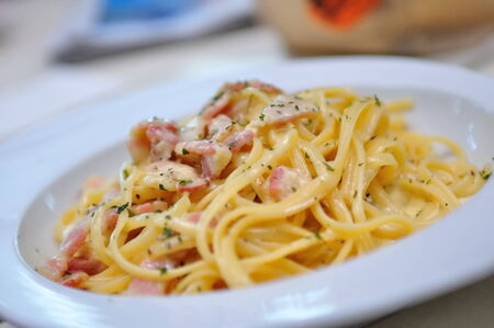 Plate of delicious carbonara with cheese and ham toppingの写真素材