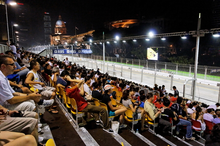 SINGAPORE - SEPTEMBER 26: F1 fans at the 2009 Formula One Singapore Singtel Grand Prix grand stand September 26, 2009 in Singapore.のeditorial素材