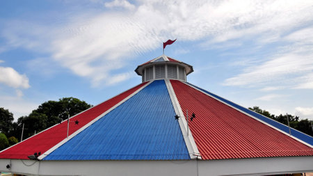 Bright red and blue roof of a building in theme parkの写真素材
