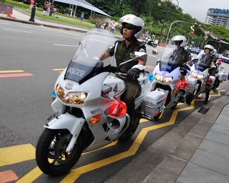 SINGAPORE - DECEMBER 07: Military police on motorbikes, ready to direct traffic for change of President's guards parade December 07, 2008 in Singaporeのeditorial素材