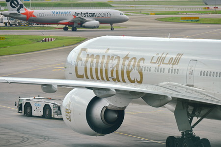 SINGAPORE - JANUARY 10: Emirates Boeing 777-300ER being pushed back at Changi Airport on January 10,...