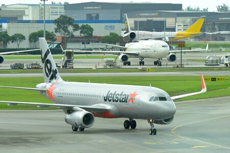 SINGAPORE - JANUARY 10: Jetstar Asia Airbus 320 low cost carrier taxiing to gate at Changi Airport on January 10, 2015 in Singaporeのeditorial素材