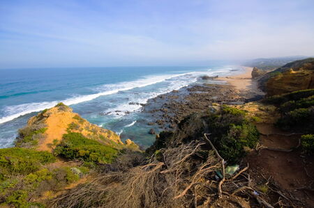 Cliff and beach along Great Ocean Drive in Australiaの写真素材