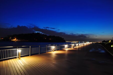 Shoreline at night against blue evening skyの写真素材