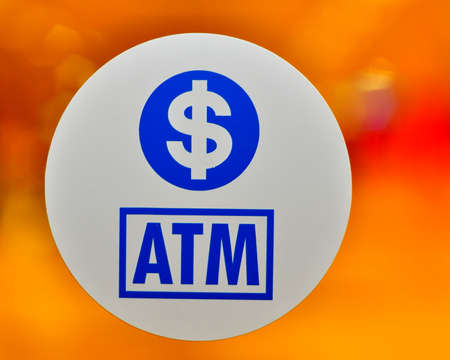 Circular ATM sign against vibrant backgroundの写真素材